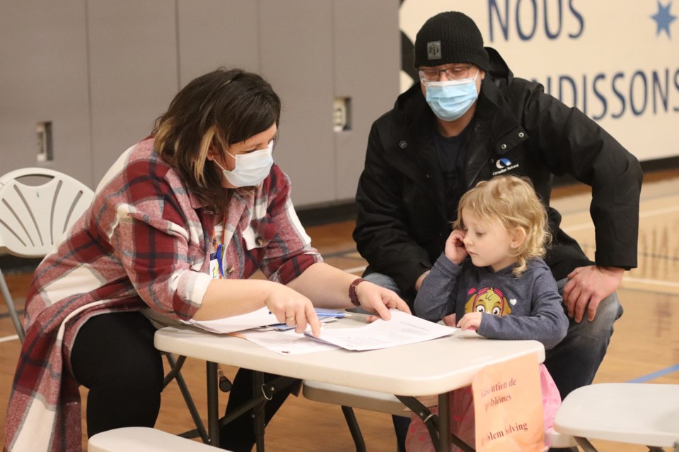 David Fontaine, pictured behind his daughter Lilly Rose Fontaine, speaks and consults with Michelle Duffy with St. Paul Education. "I want the best for my daughter," says David.