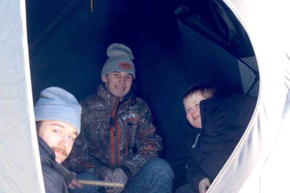 Bodee Weiss (left), Ludovik Tardif (middle), and Kesler Graham are hopeful to catch their pike.