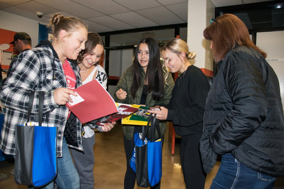 From left to right are Sakura Lalonde, Lily Paranteau, Selena Woodgate-Beauregard, Chloe McDonald, and Bev McDonald, chatting about potential career paths during the Oct. 24 post-secondary night held at St. Paul Regional High School.
