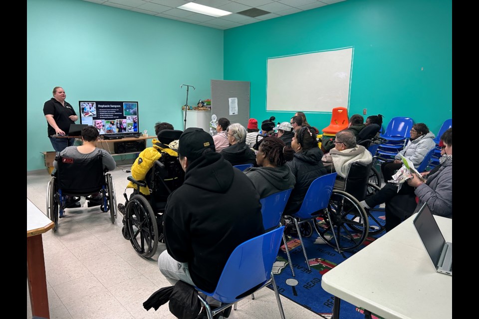 Stephanie Sampson, education and outreach coordinator at LICA, speaks to St. Paul Abilities Network clients at the library about animals.