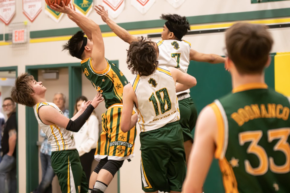 Glendon Sr. High School Nobles (white jersey) and Glendon Globetrotters (green jersey) kicks off the tournament.