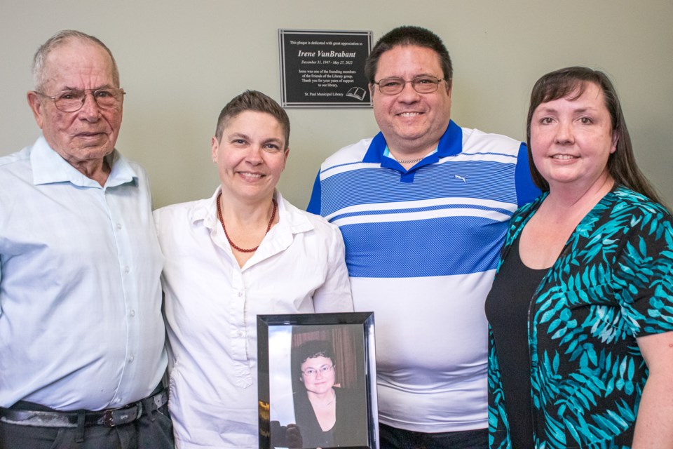The VanBrabant family takes a family photo while holding a photo of Irene. From left-to-right are Guy, Diane, Réal and his wife, Pauline. Missing from the photos is Irene's other daughter, Denise Hutscal, and her husband Ray.