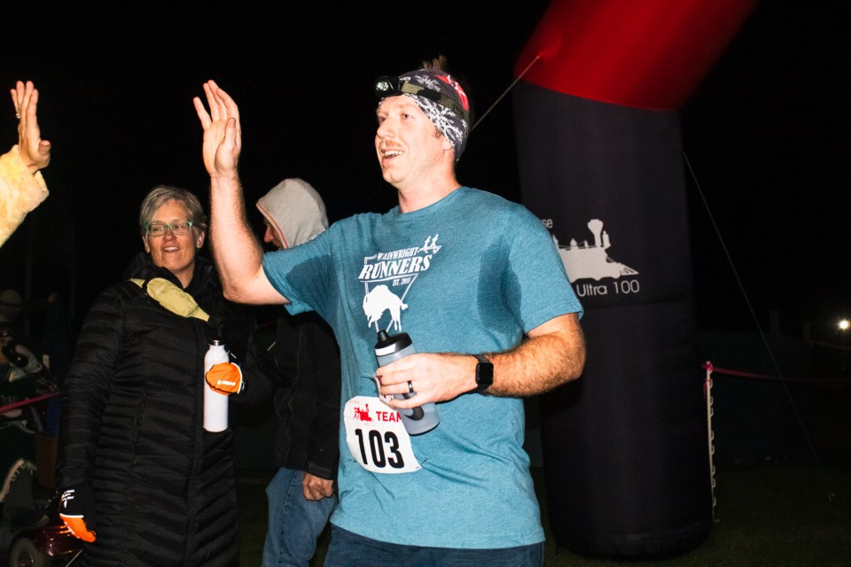 The "Eight Will Be Enough" 100-mile relay team's Graham Mater completes the race, with the team placing first.
