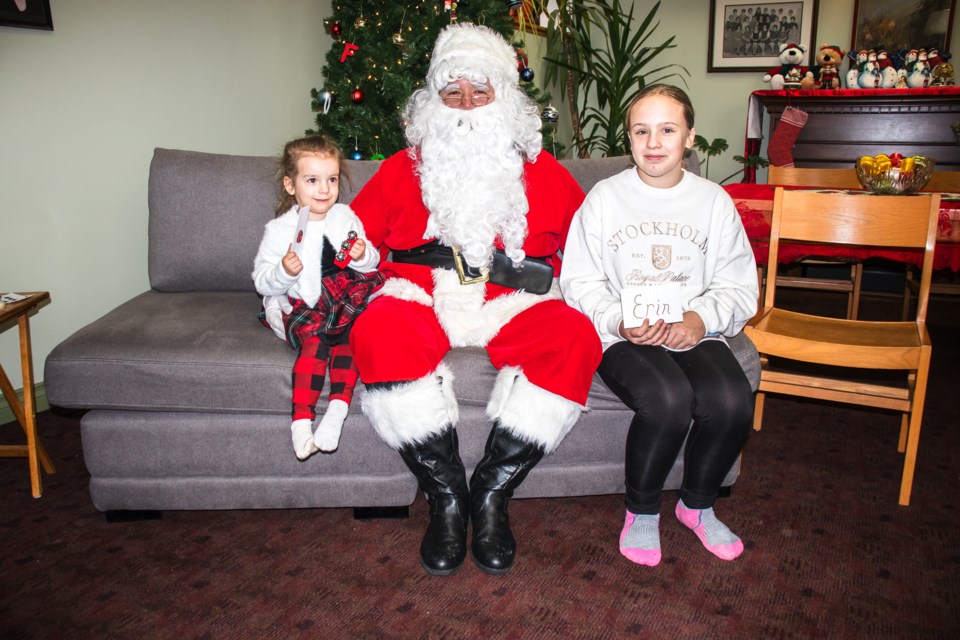 Evelynn and Erin Golden chat with Santa at the St. Paul Municipal Library on Dec. 14.