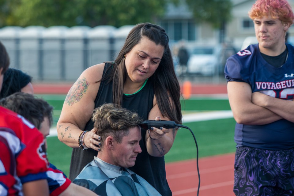 Serena Critch shaves heads during the Scott MacDonald Memorial fundraiser on Sept. 21. The event acts as a way to raise funds to support those battling cancer.