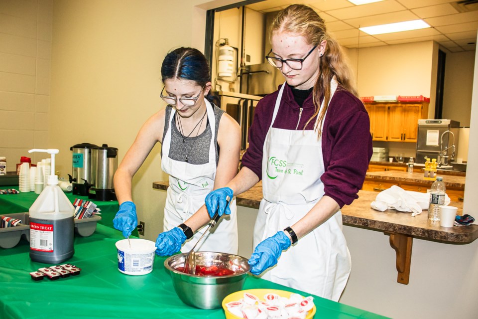 Fallyn Dechaine (left) and Hannah Poulin serving the pancake dinner.