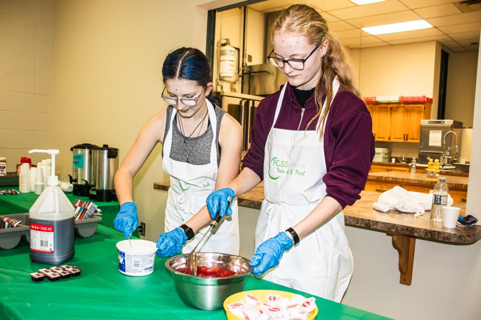 Fallyn Dechaine (left) and Hannah Poulin serving the pancake dinner.