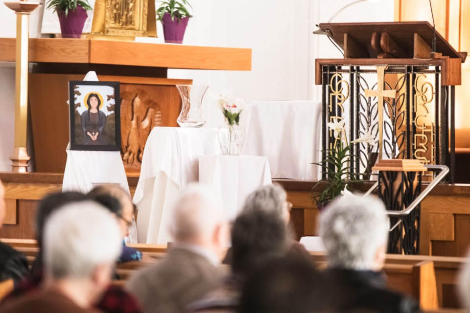 Near the altar is the image of St. Kateri Tekakwitha and a table with vases where parishioners later placed lilies during the mass.
