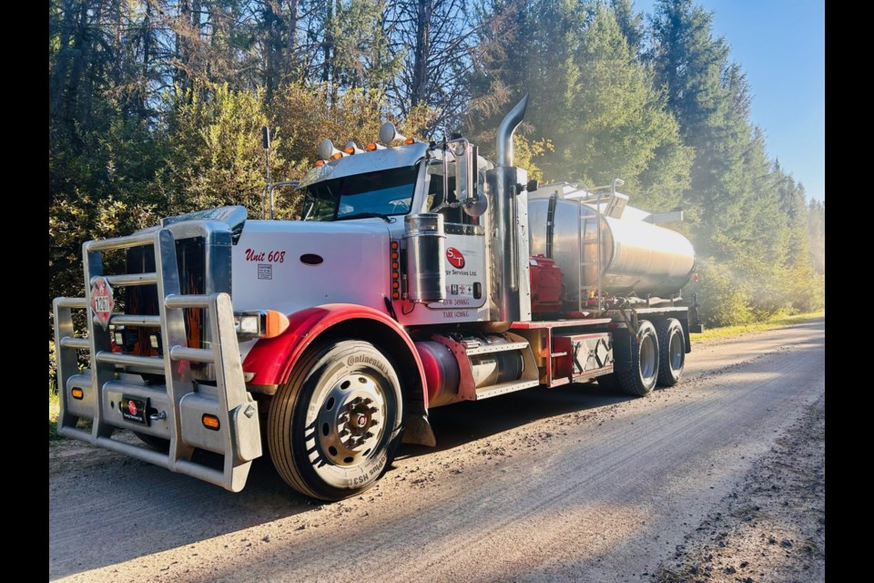 An S&T Energy Services truck unit driving down a road.