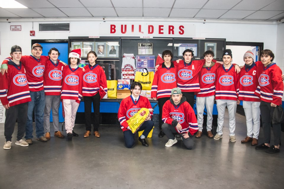 St. Paul Canadiens' U18 team helps with dropping off food donations for the Santa's Food Drive in St. Paul.