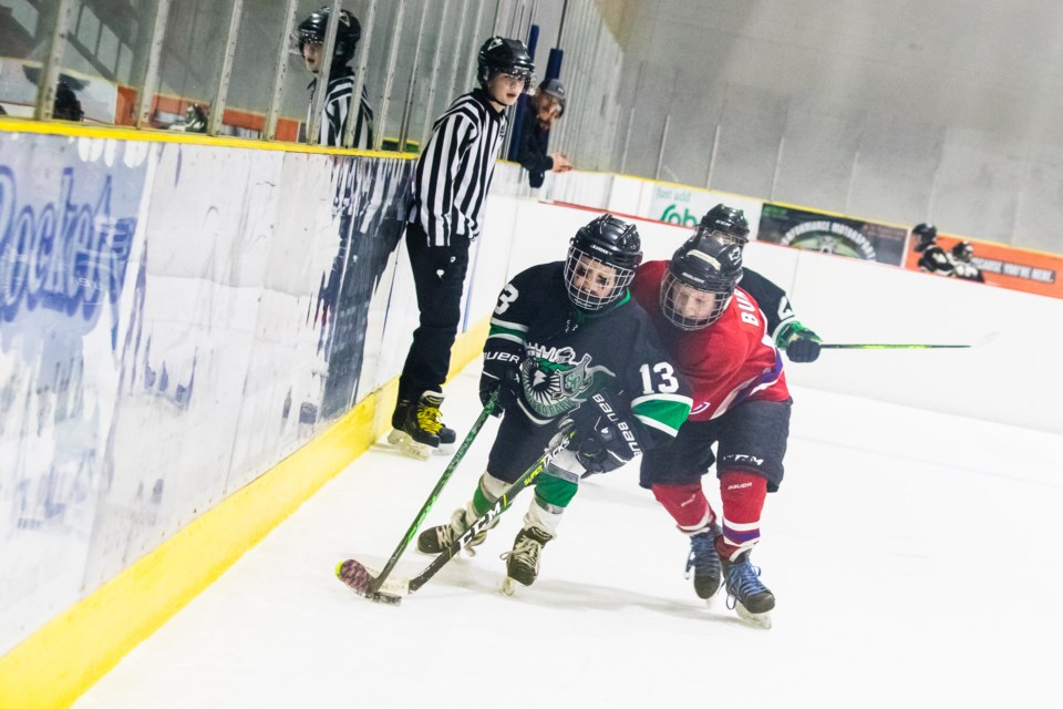 A U9 St. Paul hockey team faces off against the Sherwood Park Warriors.