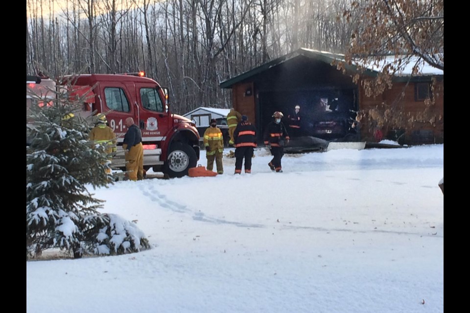 Fire crews outside the garage where Tuesday afternoon's fire at a Lakeview Estates home is believed to have begun.  No one was seriously injured in the fire.    Image Rob McKinley