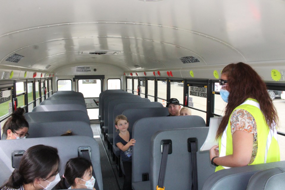 NLPS bus driver Marlena Bowring explains some of the rules for riding on the school bus to new students and their families during Tuesday's Meet the Bus event at Vera M. Welsh.