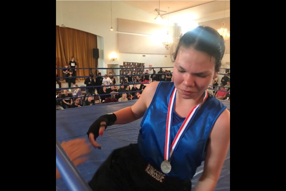 Lac La Biche Boxing Club's Maria Laboucane leaves the ring with her silver medal after the awards presentations at the recent Golden Gloves event in Edmonton. Laboucane fought former world champion muay-thai figher Jordan Dobie.