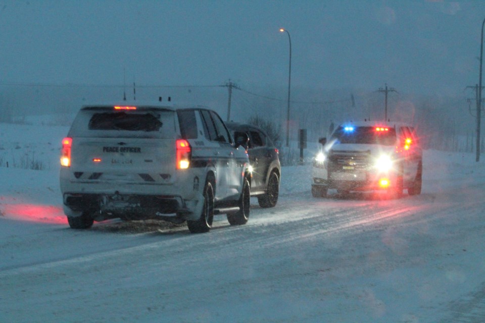 Lac La Biche County peace officer vehicles box in a dark-coloured SUV at a traffic stop near the Ramada Hotel on Friday afternoon. Police say the driver failed to stop at a stop sign and then failed to stop for police. 