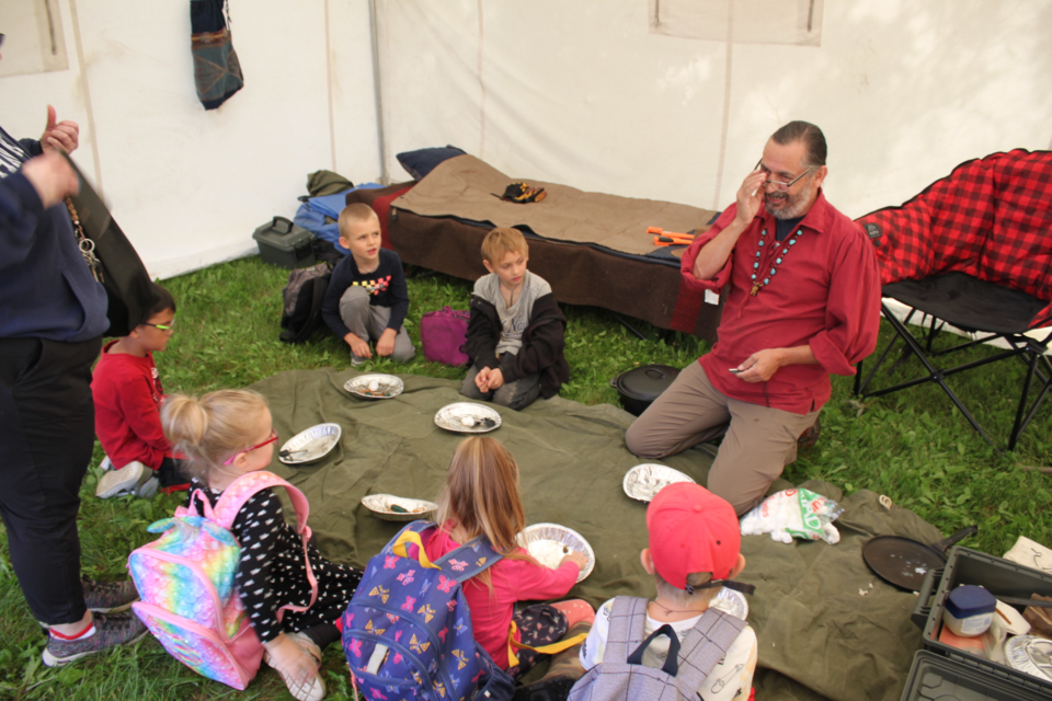 John Ritchie of Kikino Metis Settlement shared a great deal of his knowledge about wilderness survival with these eager kids who came by for a demonstration on how to make a fire using only flint and steel.