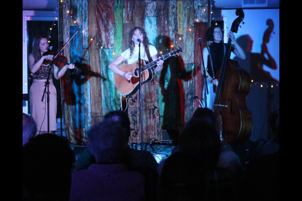 Maddie Storvold on vocals with trio members Aline Deanna on the  fiddle and Jill McKenna on the upright bass enertained at the first Music in the Forest performance of 2023.