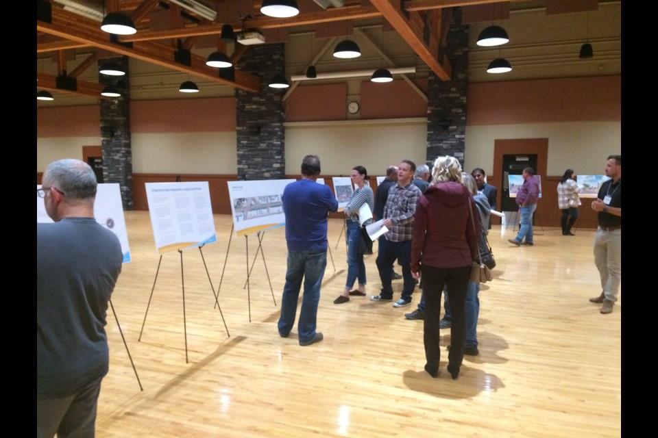 Residents look over the information cards on display at the Main Street open house.  