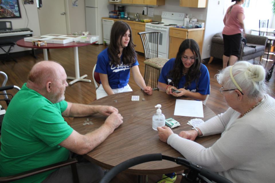  James Ratcliffe and Albertine Bourque, residents of Lacalta Lodge in Lac La Biche, found themselves facing some friendly competition during a bingo match against members of the Dodgers U15 girls’ softball team on Saturday. They are joined by players Marley Umble and Amena Abougouche. / Chris McGarry photo.