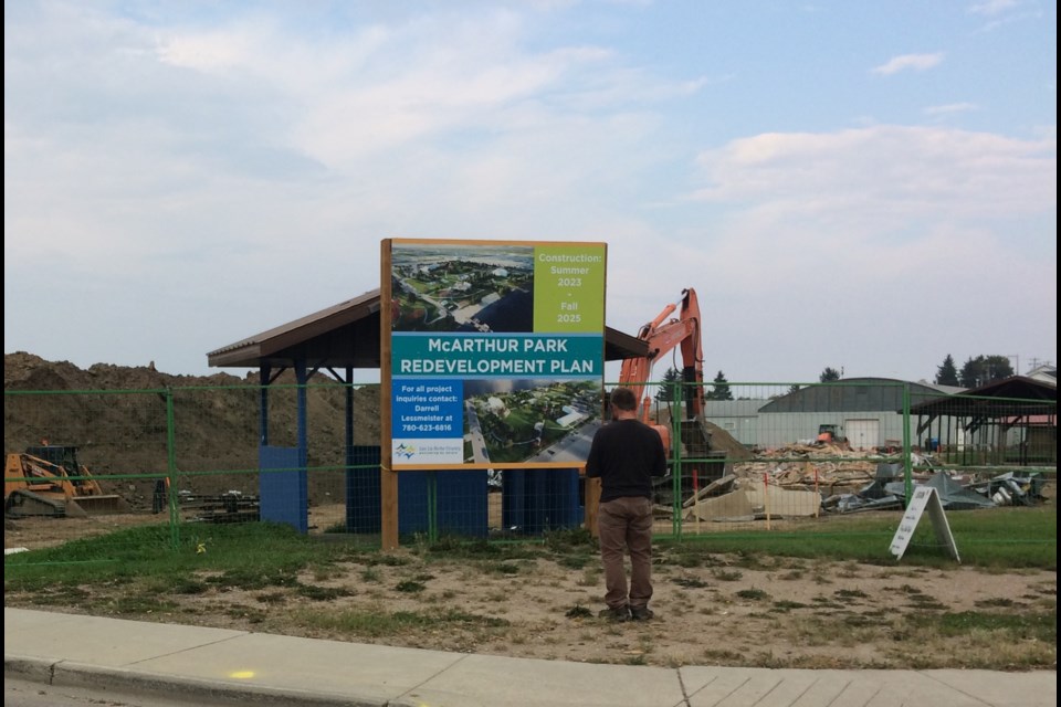 A supervisor at the McArthur Park project stands near the debris left after machines tore down the multicultural building that was part of the Lac La Biche Recreation Grounds.