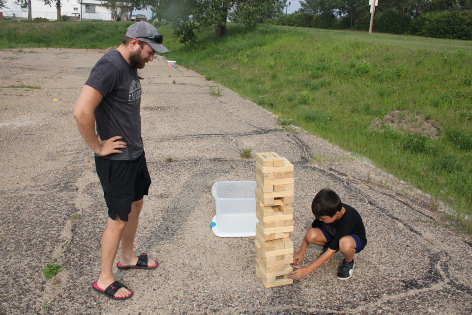 The stacking game of Jenga can be challenging at the best of times — even more so when you're playing the 'big-block' version. But don't tell that to Mason White. The youngster — with the help of his uncle Michael Shewchuk were in top form as they competed against each other at Tuesday's Fun Van stop at the museum parkng lot.