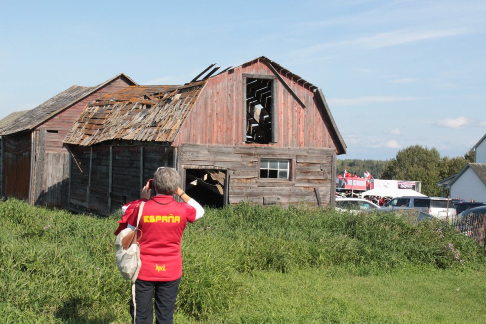 A visiting athlete from Spain during the 2019 world archery championships hosted in Lac La Biche County takes a photo of the old barn at the Mission site. The Mission has been the backdrop of Canada Day celebrations and other cultural events for decades.