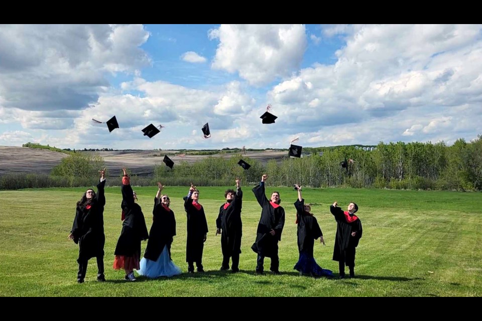 New Myrnam School and Myrnam Outreach and Homeschool Centre’s Class of 2024 (left to right) Marshall Willier, Nelly Boese, Hellen Briggs, Harlen Saskiw, Gabriel Goddard, Noah Jacula, RaeBecca Pashulka and Lynyra Crossan toss their mortarboards high in the air after their Graduation Ceremonies on Saturday, May 25.