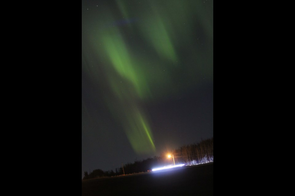 Holiday Monday night Northern Lights over Lac La Biche — and this vehicle driving along the Young's Beach Road — helped to make the 'back to work' preparation a little brighter.