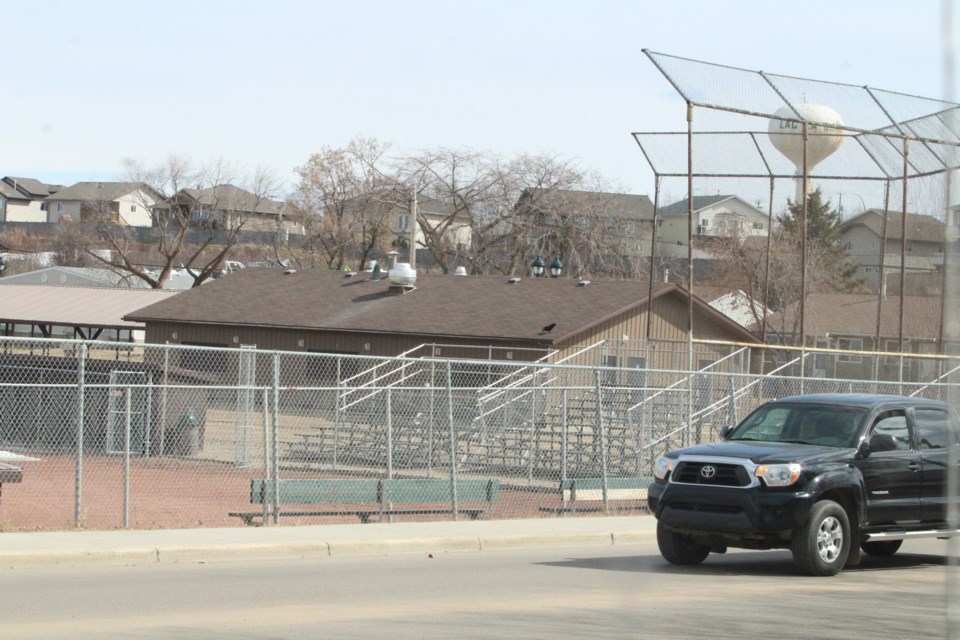 A vehicle drives past the main 1 ball diamond in downtown Lac La Biche. The sports field's intended replacement diamond, which has been in the works for more than two years, isn't the same size.   