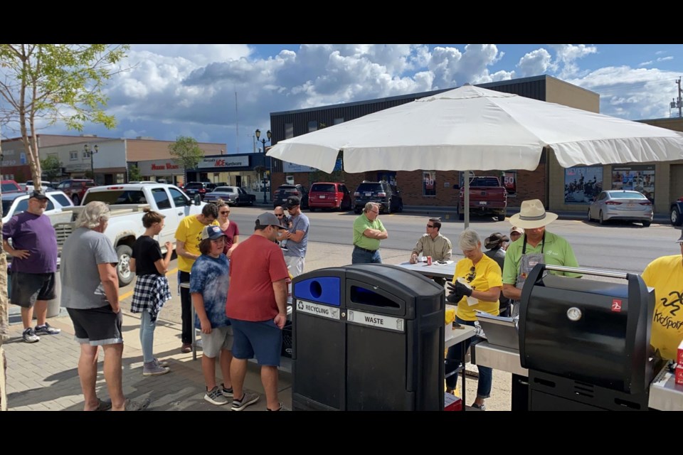 The sidewalk in front of Omar's Barber Shop was busy with an afternoon fundraing bbq for KidSport on Aug. 20