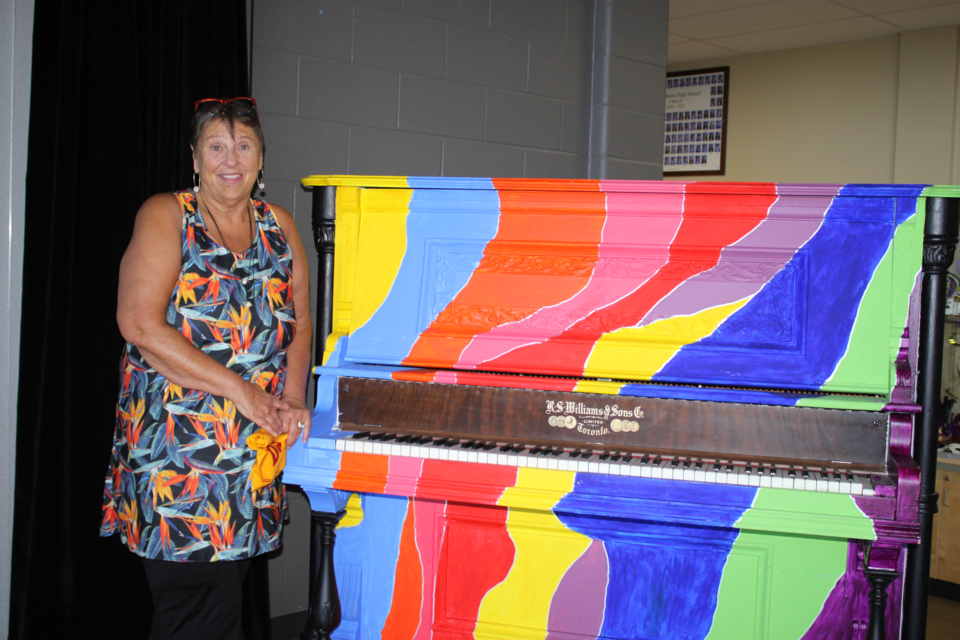 
Pat Boon-Anderson stands beside the bright piano in the J. A. Williams High School foyer. Boon-Anderson recently retired after a colourful 44 year teaching career. 