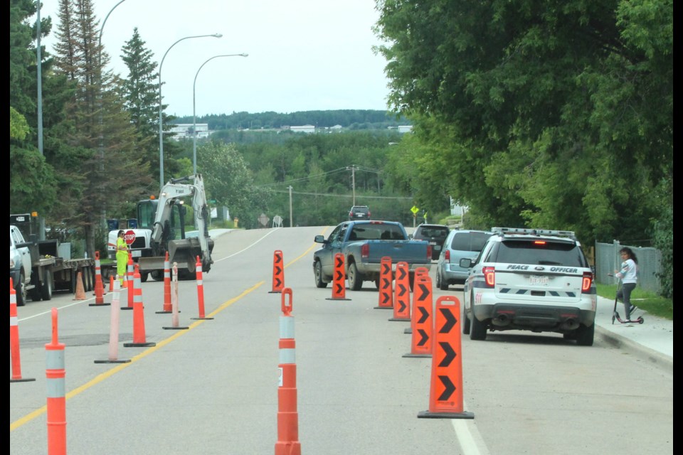 A Lac La Biche County peace officer stopped at a residential construction zone has a quick word with a youngster on the sidewalk.         Image: Rob McKinley