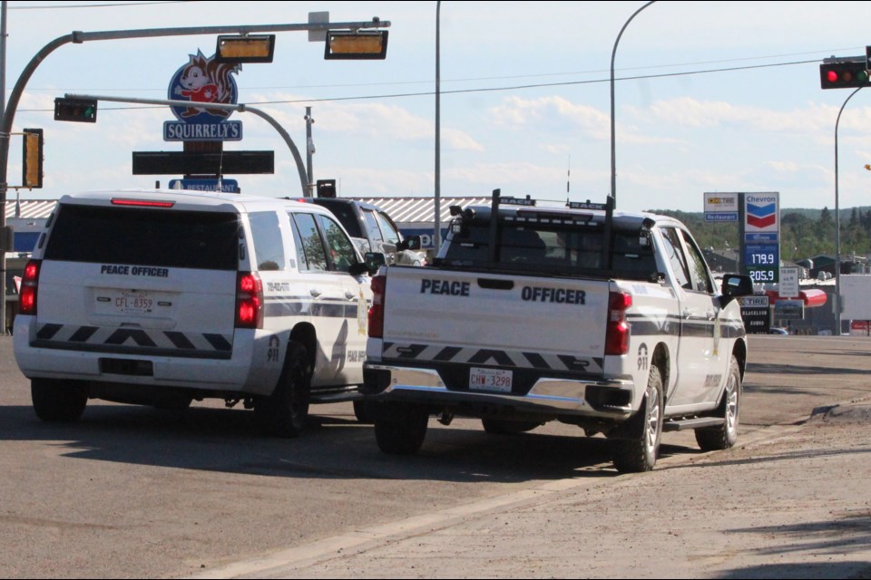 Lac La Biche County peace officers watch for driving infractions at a Main Street intersection on Wednesday night when fuel prices were still near $1.80 a litre in the community. The premier and the area's MLA are investigating to see if provincial prices for fuel are a crime.