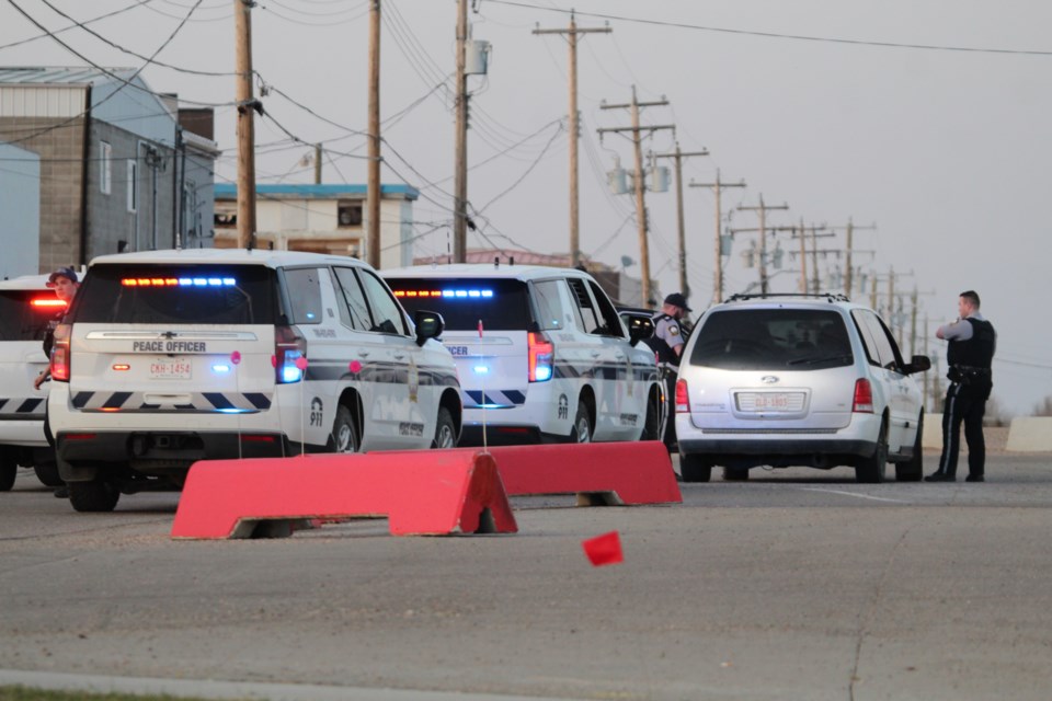 Lac La Biche County Community Peace Officers conduct a traffic stop on Wednesday night along the back-alley south of Main Street. Although three vehicles were part of the stop, officers let the vehicle drive on after a quick document check. Police have increased patrols in the downtown area due to the downtown construction project.