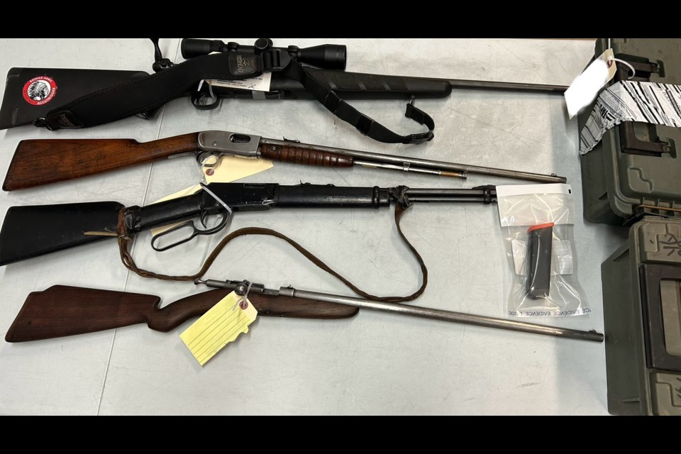 Four firearms and a modified weapon accessory are part of the items police say they seized in a recent search in Lac La Biche County.