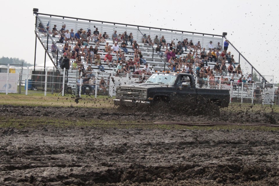 A Chevy shortbox makes a splash in front of the grandstand on Sunday's racing at the Plamondon Mud Bogs.