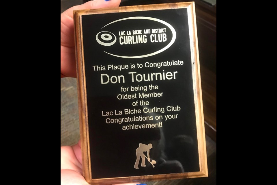 The plaque, presented to Tournier with a new curling jacket, for his years of local dedication to the sport.