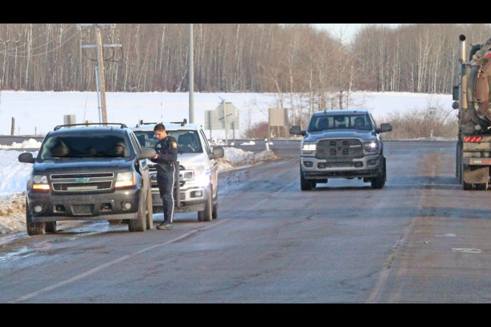 A Lac La Biche County peace officer speaks to the occupants of a vehicle pulled over near the Truck Route and Highway 36 intersection on Friday afternoon. Travel and intersection safety have been focus themes for local RCMP in January.
