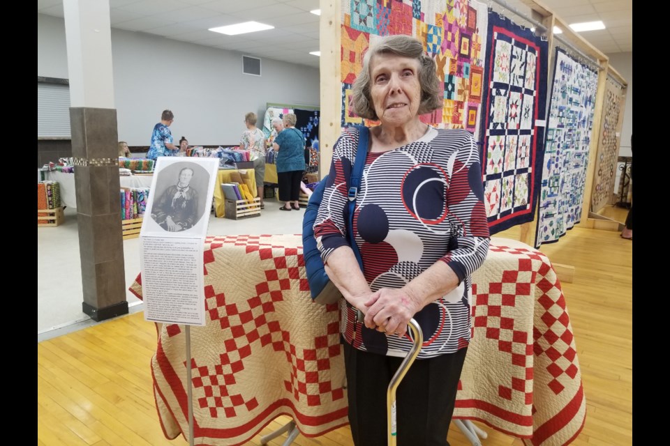 A 145-year-old quilt was on display at Riverhurst Hall during the Fall Into Quilting event. Pictured with the quilt is Jean Giesbrecht. 