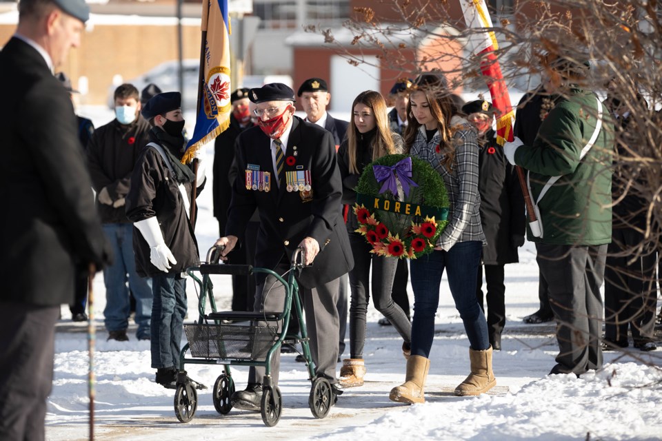 Veteran Mike Lotoski lays the Korean War wreath at the cenotaph in St. Paul on Wednesday morning, with his granddaughters walking next to him. A small group gathered for the short Remembrance Day ceremony. Janice Huser photo.
