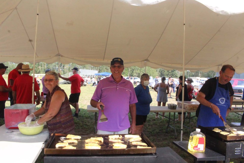 Rotary Club member Tim Polzin and other club members at last year's Summer Days fish fry. 