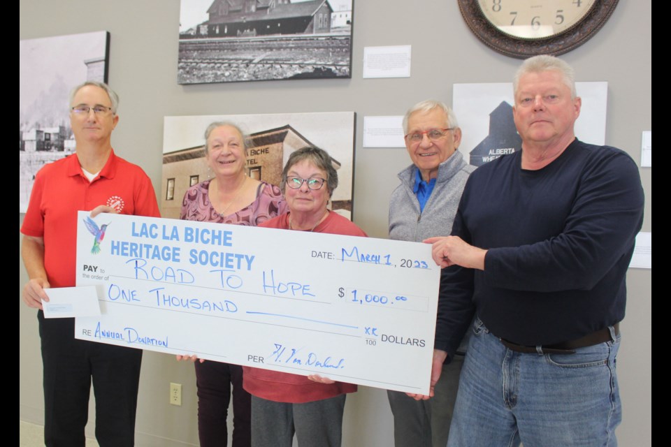Blair Norton (left) receives a $1,000 for the Road To Hope Foundation from Lac La Biche Heritage Society members Mona Frederick, Sharon Hutchinson, Les Diachinsky and Henry VanDorland.
