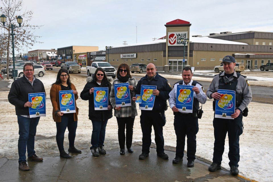 With Lac La Biche County’s new Safe Place program, participating local businesses, community facilities and schools can ask for special decals and posters to identify themselves as locations where victims or witnesses of hate crime, bullying and harassment can go to safely get help. Pictured here are representatives of Lac La Biche County and some of the multiple businesses that have already signed up to participate in the program.  (l-r) Jim Piquette with Re/Max La Biche Realty, Tamam Hattum with Queen Bean Café & Bakery, Debbie Jansen with Portage College, Deputy Mayor Charlyn Moore, School Resource Officer Glynton Brittain, Enforcement Services Manager Chris Clark and Enforcement Services Supervisor Andrew Klekta.
 
