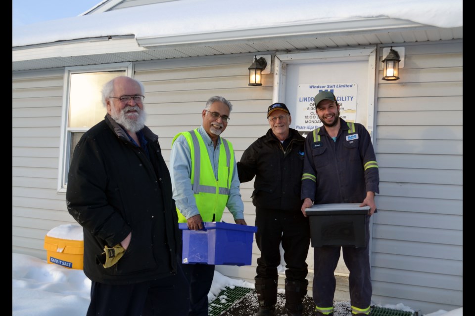 Two remaining employees at the now-closed Windsor Salt plant at Lindbergh presented two bins of the facility’s 74-year history on Friday to two men determined to preserve it. Left to right are: Elk Point Historical Society secretary-treasurer Marvin Bjornstad, Lindbergh works general manager Mohammed Shadpour, retired Windsor Salt employee Gordon Fakeley and current employee Tanner Shankowski.