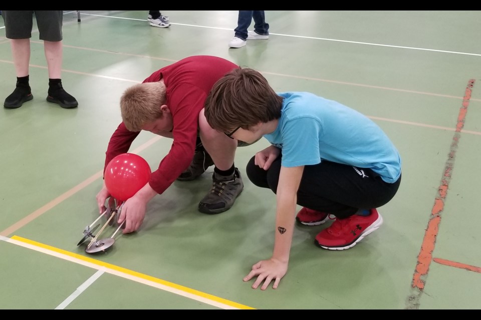 Youth create a self propelled vehicle during the June 10 Science Olympics in Cold Lake.