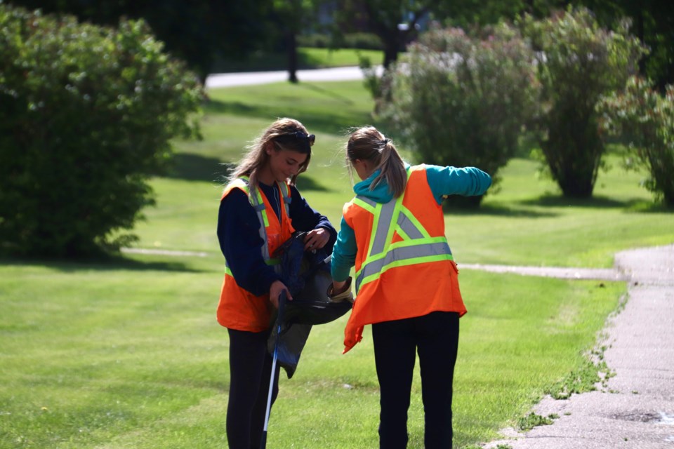 Lauren Metcalfe and Rachael Lafrance use teamwork to cleanup the debris. 