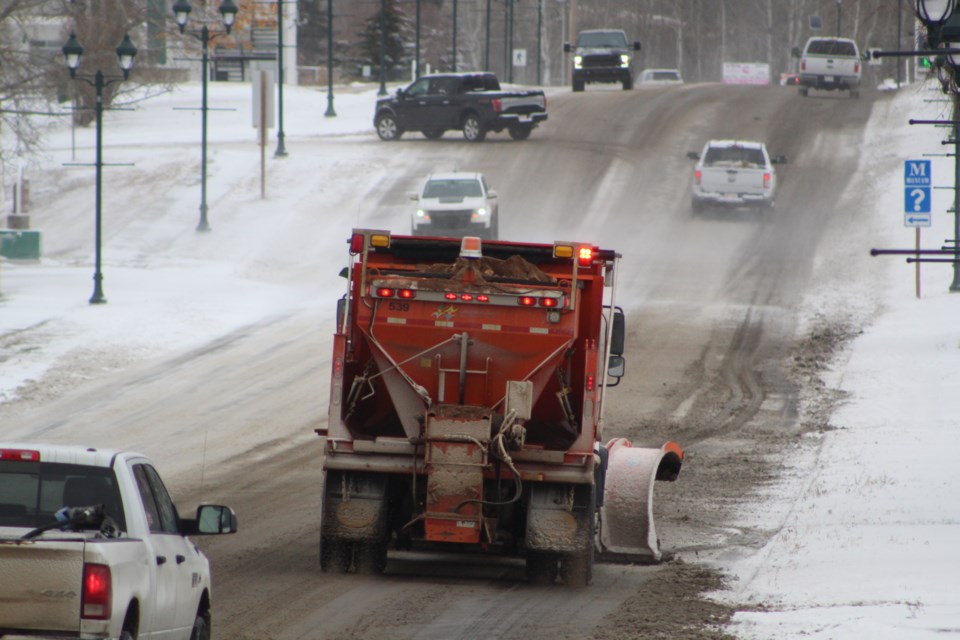 A Lac La Biche County plow truck clears a portion of Main Street that is also part of Highway 881 to Saturday afternoon.