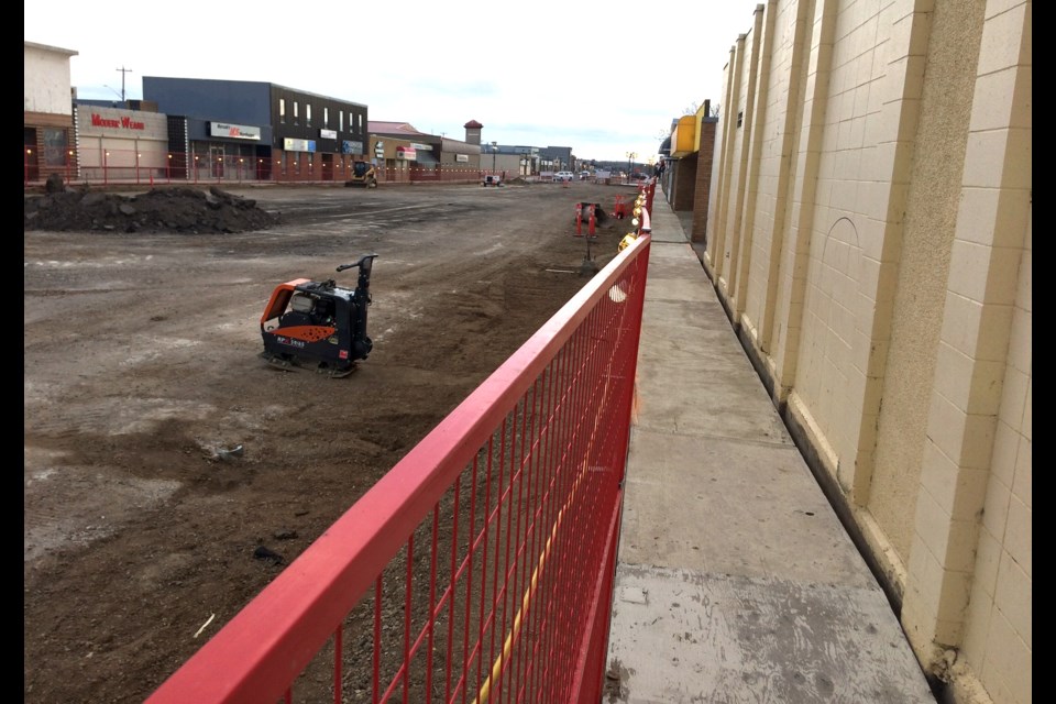 Like a long gang-plank — but you know ... a fun one.   It's not known how long the plywood sidewalk will be part of the construction zone - so enjoy it while you can.  Once the sidewalks close completely for the downtown revitalization, rear accesses will be available at most downtown stores.