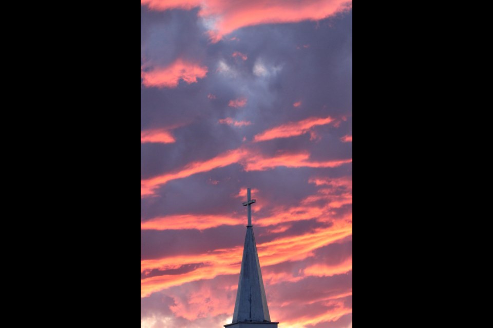 The clouds reflecting the last rays of Wednesday's sun over Lac La Biche gave the St. Andrew's Anglican Church steeple a heavenly backdrop.