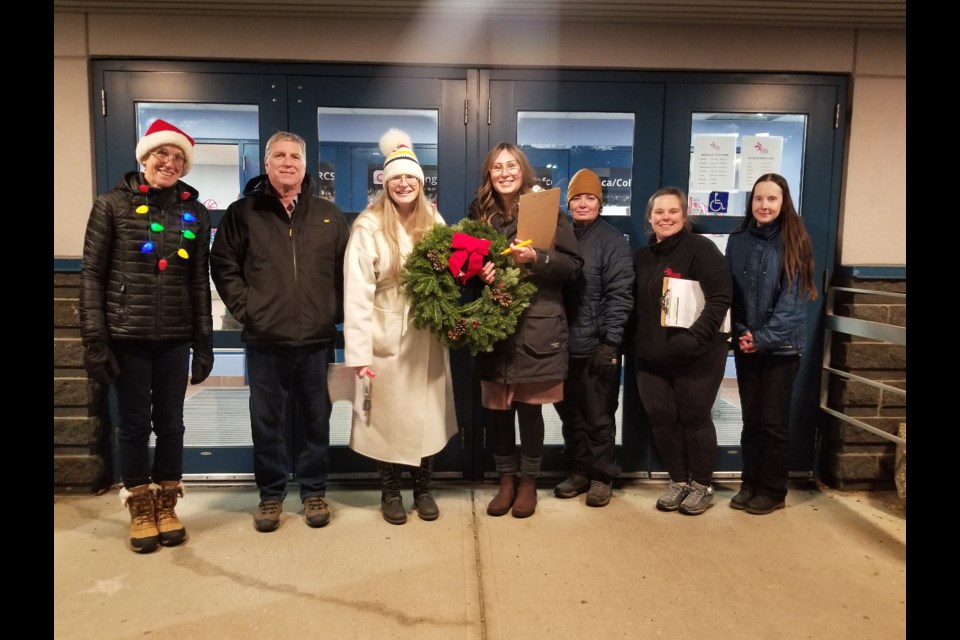 Staff with the 4 Wing Military Family Resource Centre Society and volunteers are pictured during a day of handing out wreaths.